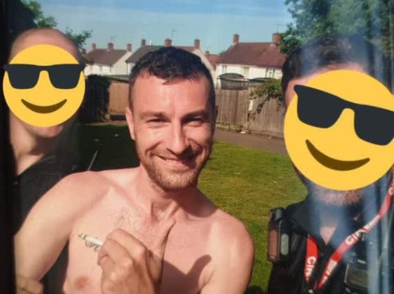 Andrew Fox in handcuffs after being arrested by police in Kettering, who hid their faces behind emojis. Photo: Northamptonshire Police/Twitter