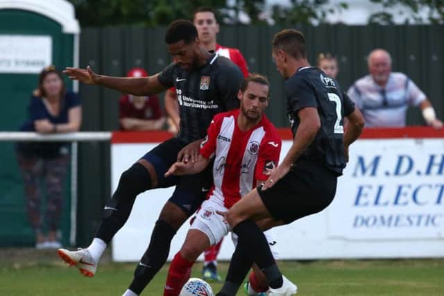 Vadaine Oliver and Joe Martin battle for possession during Cobblers' defeat to Brackley. Picture: Pete Norton
