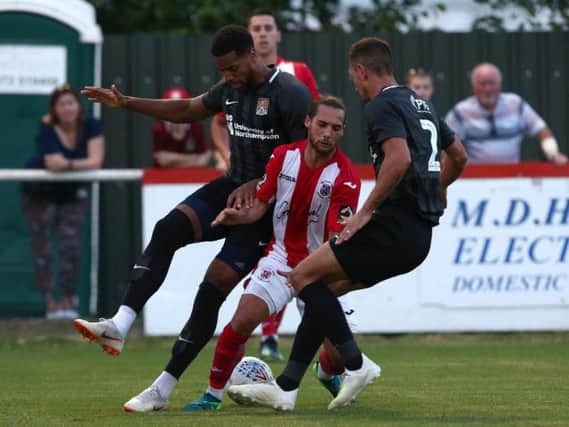 Vadaine Oliver and Joe Martin battle for possession during Cobblers' defeat to Brackley. Picture: Pete Norton