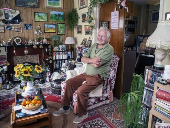 Tony Mallard sits telling stories in his Eastfield living room surrounded by his original artwork.