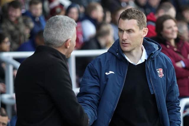 Lock horns: Keith Curle with Exeter boss Matt Taylor.