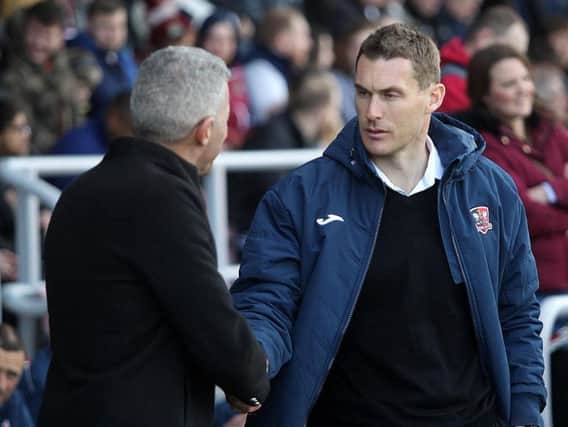 Lock horns: Keith Curle with Exeter boss Matt Taylor.