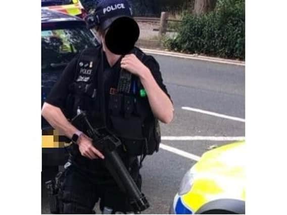 A member of the Northants Armed Response Vehicle team pictured on Crow Lane this morning.