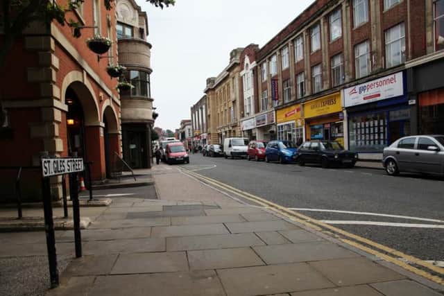 A woman and her friend were assaulted by three men in St Giles Street.