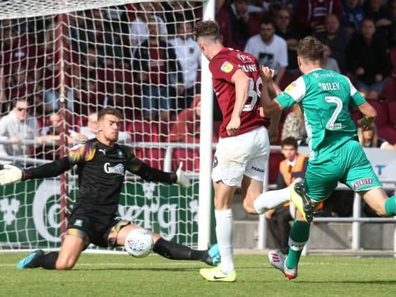 Joe Bunney almost scored his first Cobblers goal on what turned out to be his last appearance for the club, denied by Plymouth's Alex Palmer. Picture: Pete Norton