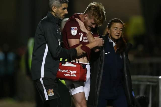 Ryan Watson is helped off the pitch after suffering a broken collarbone in the clash with Peterborough United on Tuesday night