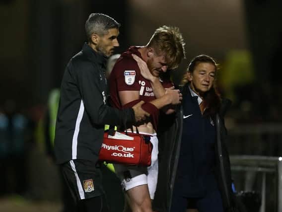 Ryan Watson is helped off the pitch after suffering a broken collarbone in the clash with Peterborough United on Tuesday night