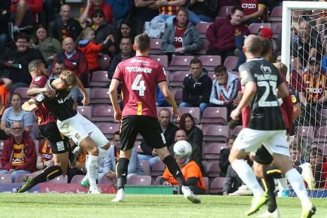 Charlie Goode heads the Cobblers in front at Bradford (Pictures: Pete Norton)