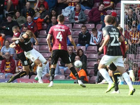 Charlie Goode heads the Cobblers in front at Bradford (Pictures: Pete Norton)