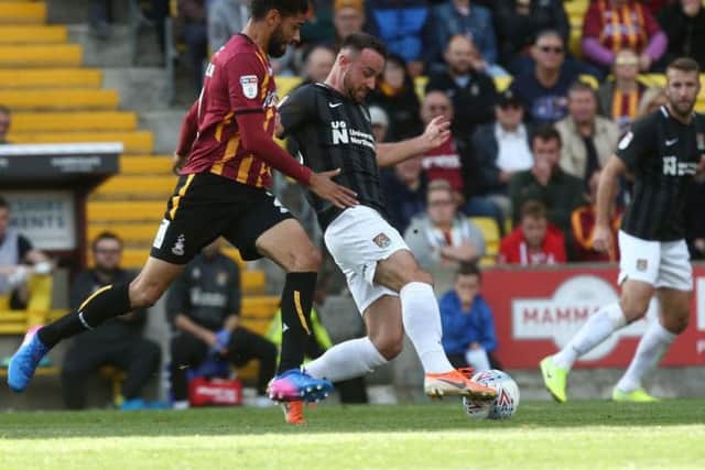 Matty Warburton keeps the ball under pressure. Pictures: Pete Norton