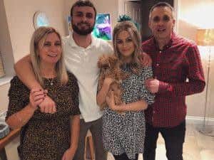 Daisy pictured with her mum, dad and brother.
