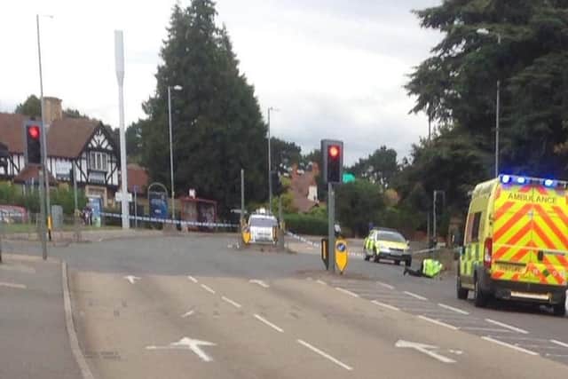 Police cars and an ambulance at the scene of a crash on Kettering Road in Northampton