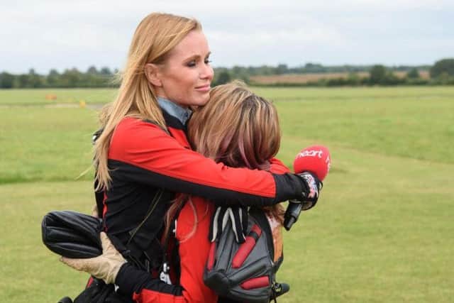 Amanda Holden gets emotional as she jumps with 17-year-old Charlotte Hatton who lost her Mother to cancer. She is from the charity Holding on Letting Go which will benefit from funds created by Globals Make Some Noise.