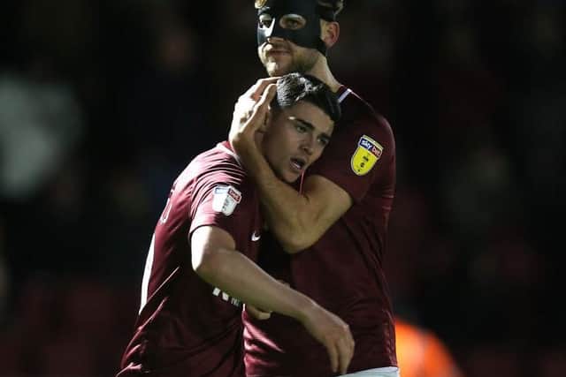 Joe Powell celebrates his match-winning strike against Newport in March with Charlie Goode