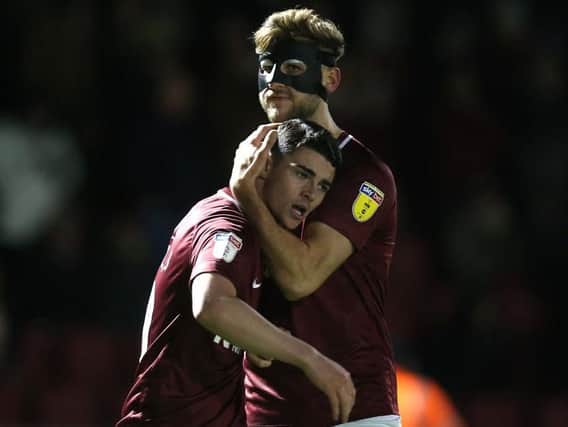 Joe Powell celebrates his match-winning strike against Newport in March with Charlie Goode