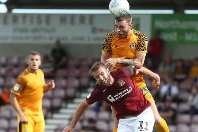 Andy Williams is beaten in the air by Newport#s Mark O'Brien