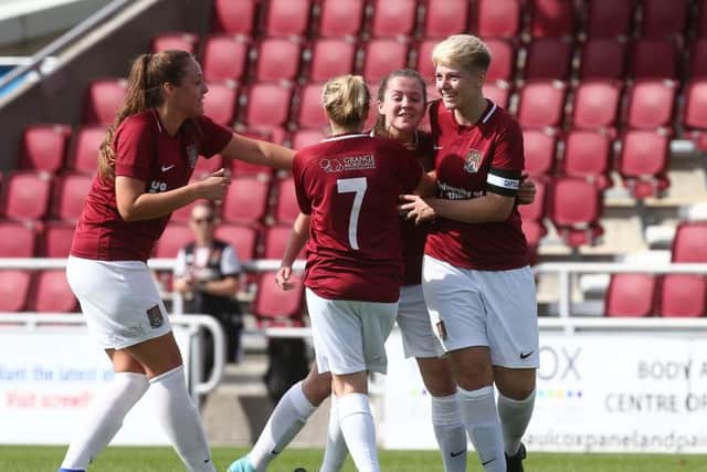 The Cobblers Ladies players celebrate Abbie Reboul's goal against Peterborough United on Sunday (Pictures: Pete Norton)