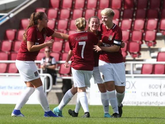 The Cobblers Ladies players celebrate Abbie Reboul's goal against Peterborough United on Sunday (Pictures: Pete Norton)