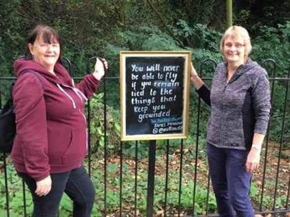 Buddies of Beckets volunteers Joy Ormond and Sue Ward with the poem blackboard in the park