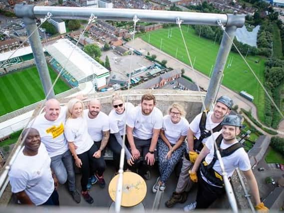 The David Wilson Homes representatives at the top of the tower after completing the abseil