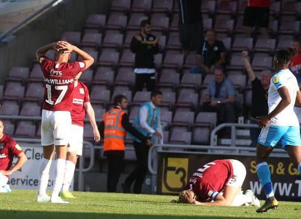 Gutted: Cobblers players are crestfallen after Joe Martin's 95th minute own goal. Picture: Pete Norton