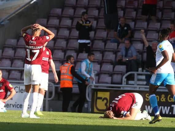 Gutted: Cobblers players are crestfallen after Joe Martin's 95th minute own goal. Picture: Pete Norton