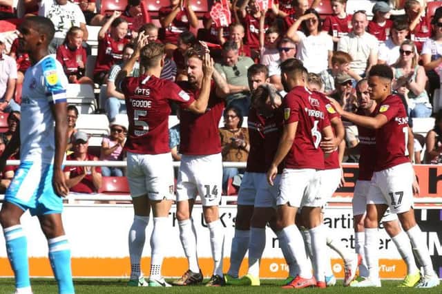 The Cobblers players celebrate Chris Lines' first-half penalty (Pictures: Pete Norton)