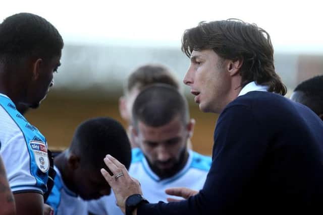 Crawley boss Gabriele Ciofi gets his message across to his players during a drinks break