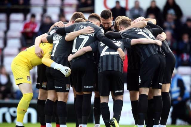 Cobblers gather for a pre-match huddle. Picture: Pete Norton