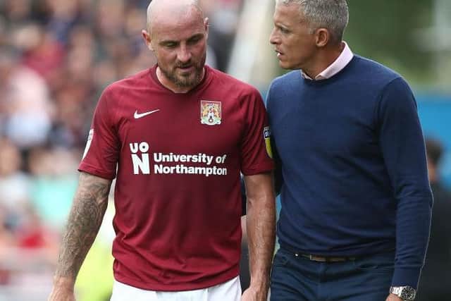 Keith Curle chats to Alan McCormack as the player leaves the field having suffered an injury in the opening day defeat to Walsall