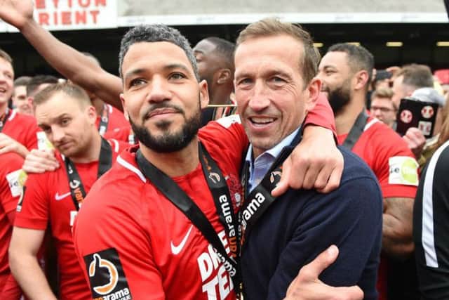Justin Edinburgh celebrates with Jobi McAnuff after Leyton Orient clinched the National League title in April