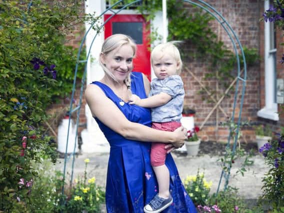 Tearoom boss Emily Armstrong with her son pictured in their Wootton garden.