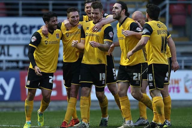 The Cobblers players celebrate James Collins firing them into a 3-0 lead at Leyton Orient in February, 2016