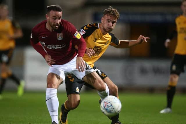 Matty Warburton battles for the ball in the clash at Cambridge United (Pictures: Pete Norton)