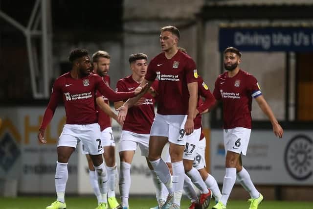 The Cobblers players celebrate Harry Smith's goal against Cambridge United (Pictures: Pete Norton)