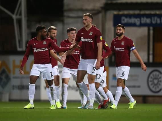 The Cobblers players celebrate Harry Smith's goal against Cambridge United (Pictures: Pete Norton)