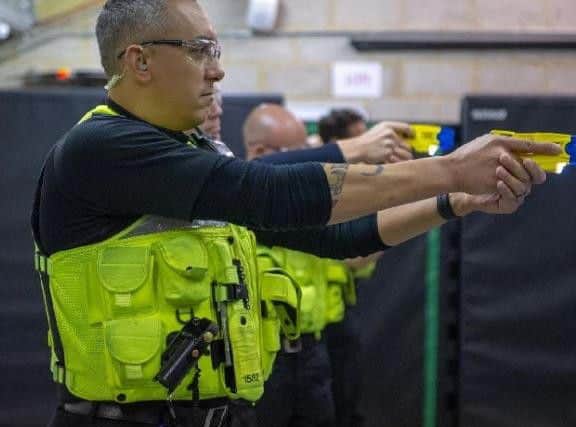 An officer practicing using a Taser back in August.