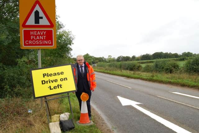 South Northamptonshire Council Leader, Cllr Ian McCord, with one of the temporary road signs at RAF Croughton.