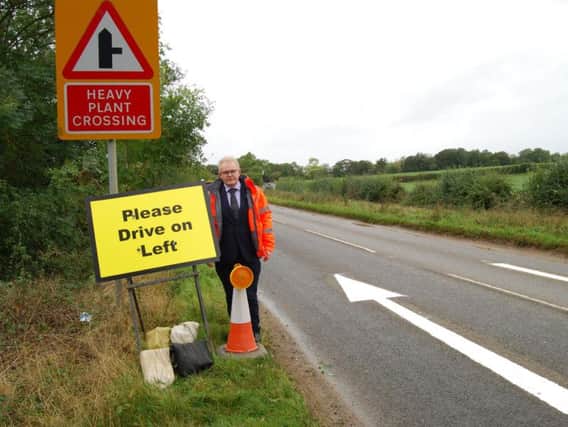 South Northamptonshire Council Leader, Cllr Ian McCord, with one of the temporary road signs at RAF Croughton.