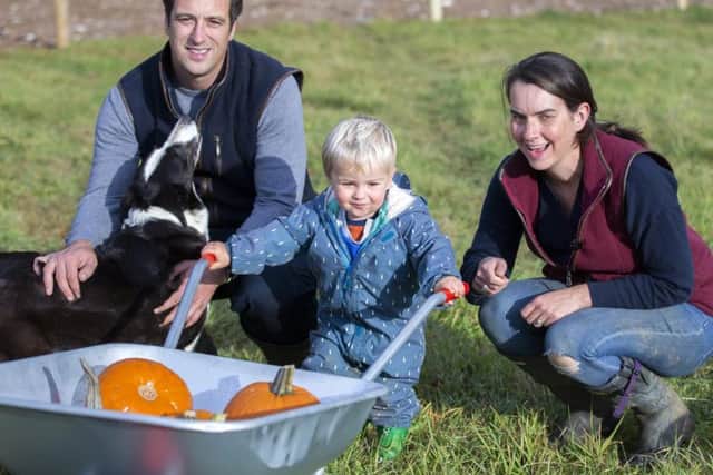 Farmer Tom Harris and his wife Lucy pictured with their son, George. Credit: Kirsty Edmonds.