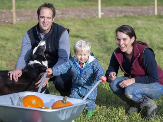 Farmer Tom Harris and his wife Lucy pictured with their son, George. Credit: Kirsty Edmonds.