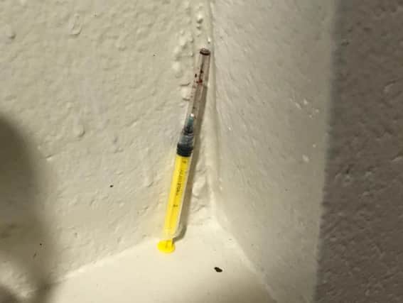 The blood-stained needle left in the hallway in Dover Court block of flats in Northampton for days