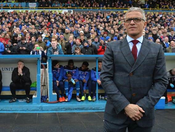 Keith Curle stands in front of the Brunton Park Paddock