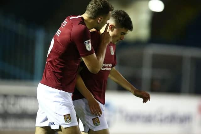 Harry Smith congratulates Scott Pollock on his goal for the Cobblers (Pictures: Pete Norton)