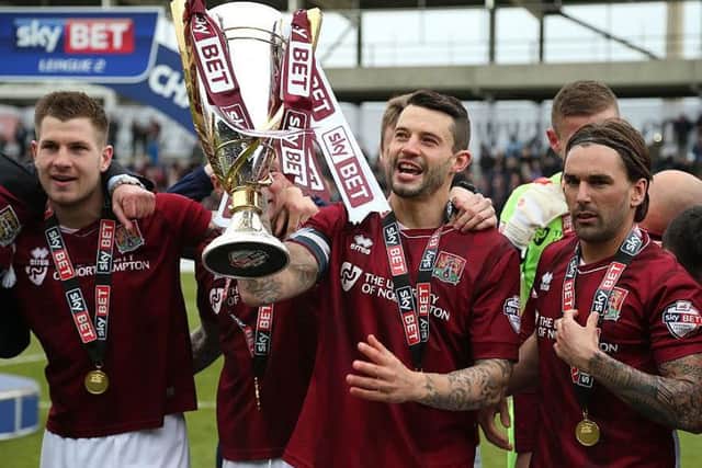 Marc Richards lifts the Sky Bet League Two trophy at Sixfields back in 2016, a moment he calls 'the proudest' of his career (Pictures: Pete Norton)