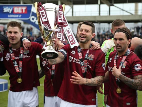 Marc Richards lifts the Sky Bet League Two trophy at Sixfields back in 2016, a moment he calls 'the proudest' of his career (Pictures: Pete Norton)