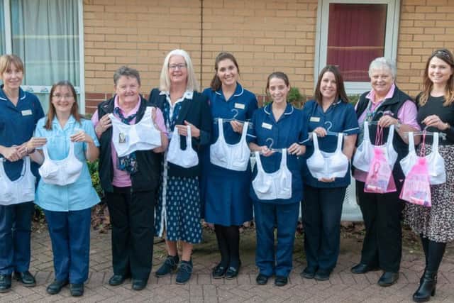 The Breast Care team at Northampton General Hospital receive the donation from Crazy Hats Breast Cancer Appeal and representatives from Avon and Amoena.