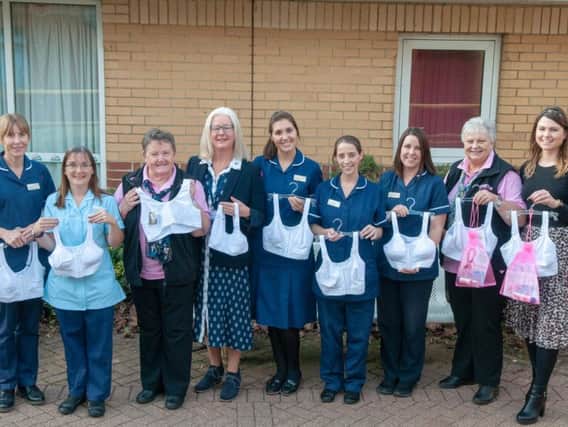 The Breast Care team at Northampton General Hospital receive the donation from Crazy Hats Breast Cancer Appeal and representatives from Avon and Amoena.