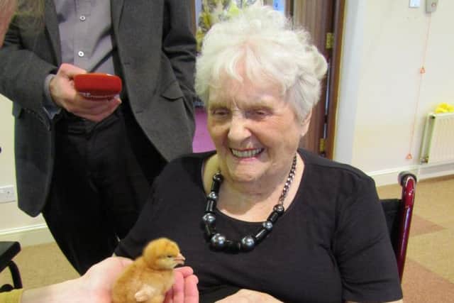 Joan pictured holding a chick during the 'Book End Project', held at the home, a project which saw children from Bridgewater Primary School join in with some of the residents to unite old and young.