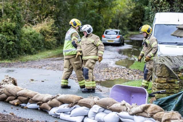 Sandbags were being put down throughout the day in a bid to stop the water gushing down the street.